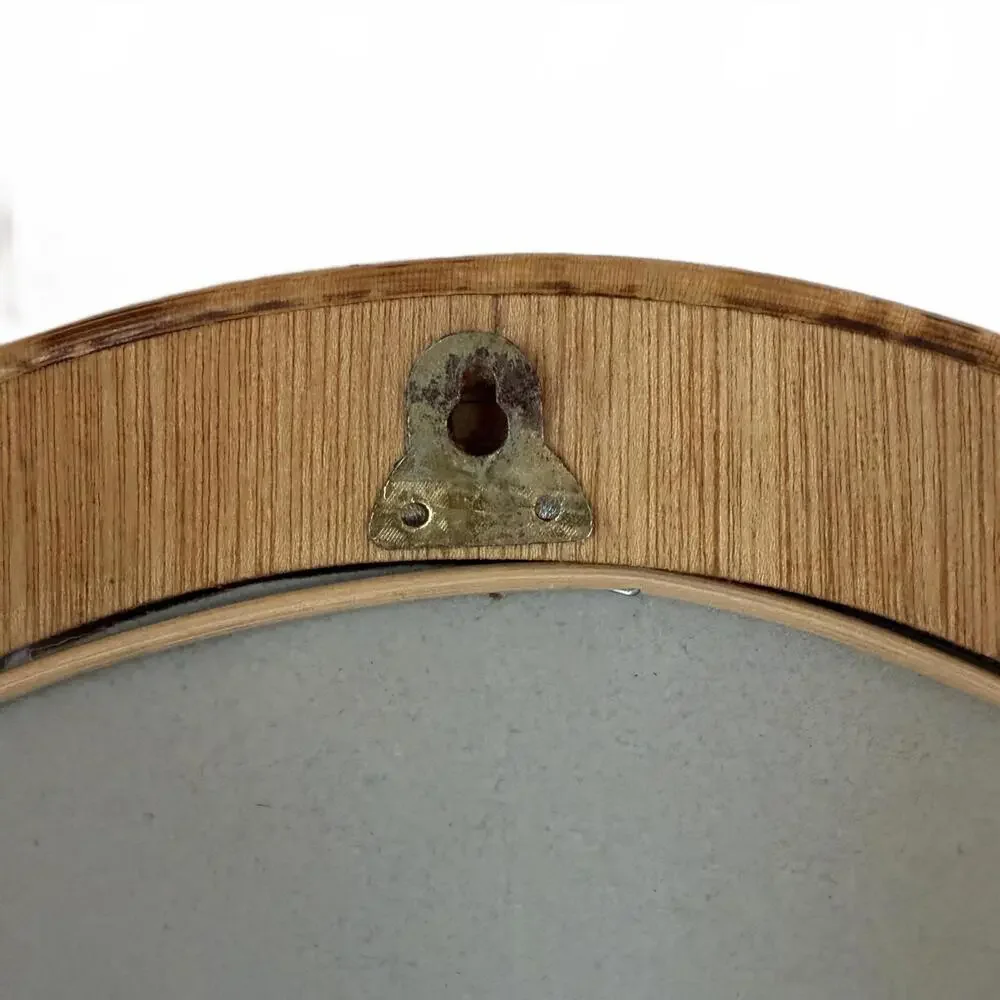 Vintage Arched rattan mirror with a natural, aged finish.